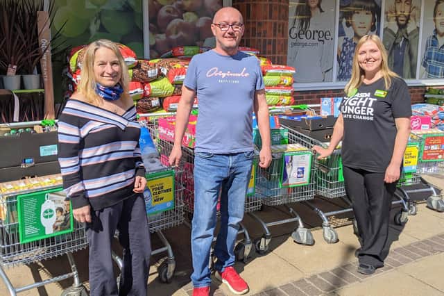From left: Rachel and Jamie Moore, founders of Care and Share Waterlooville, and Jacqui Benham, community champion for ASDA Waterlooville, with some of the trollies of donations. Picture: Emily Turner