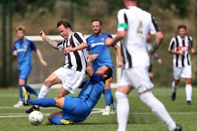 Baffins' Josh Dean challenges Josh Watts of Hayling United. Picture: Chris Moorhouse