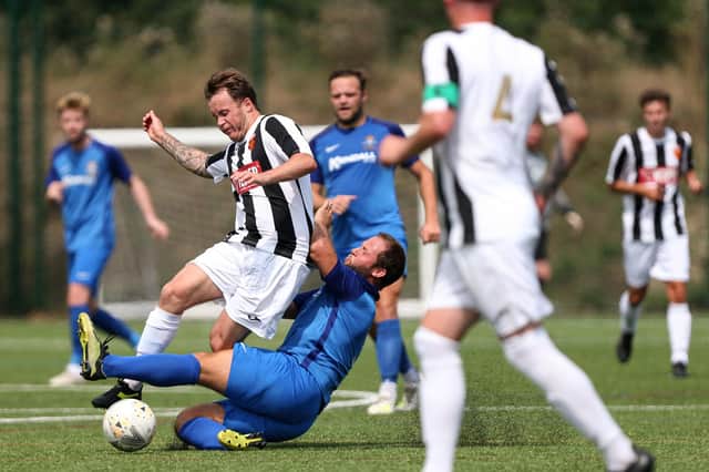 Baffins' Josh Dean challenges Josh Watts of Hayling United. Picture: Chris Moorhouse