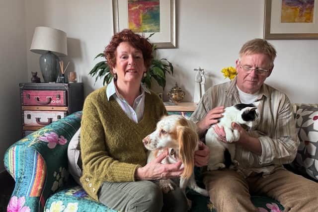 Janeen Davis, Simon Davis, and their cat, 'Miracle' and dog, 'Molly'.