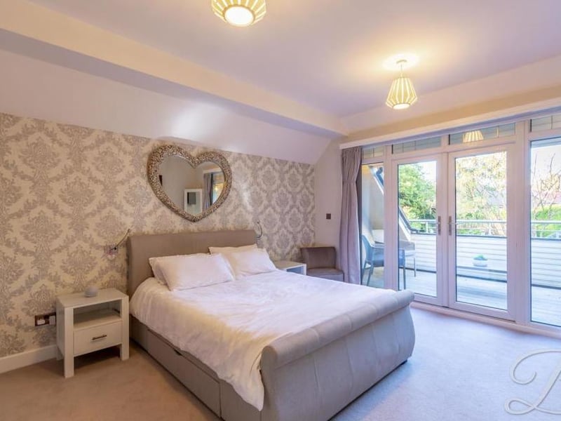 Upstairs we go now for a look at the four well-presented bedrooms, beginning with the master, which includes a balcony at the back. There are also modern, fitted wardrobes.
