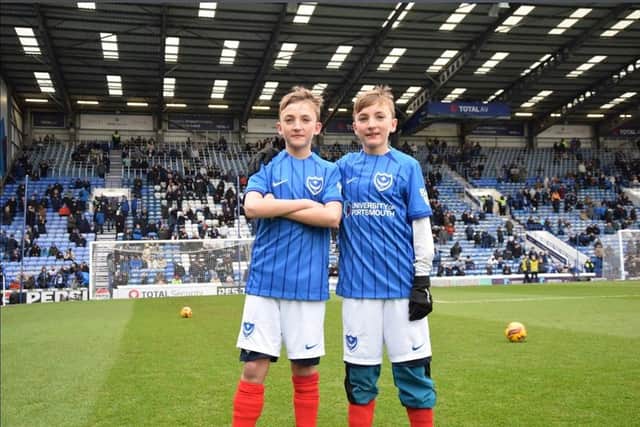 Twin Pompey fans on the pitch together