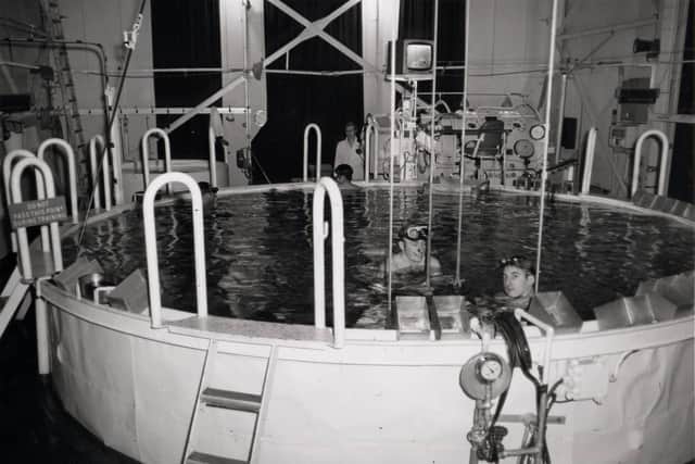 Servicemen in a submarine escape training tank. 

Credit - National Museum of the Royal Navy