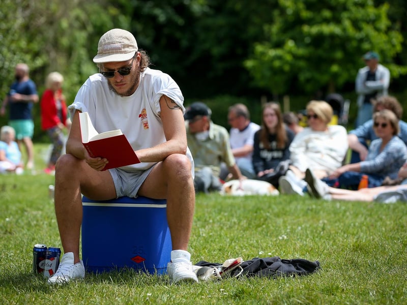 Enjoying the music with a book. Live at the Bandstand, Victoria Park, Portsmouth
Picture: Chris Moorhouse (010624-45)