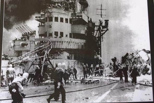 HMS Indefatigable pictured following a Japanese kamikaze attack in the Pacific. Photo: Royal Navy