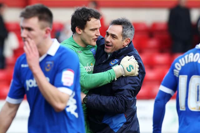 Caretaker boss Guy Whittingham celebrates Pompey victory at last following 23 matches without a win. Seen here embracing keeper Simon Eastwood. Picture: Joe Pepler