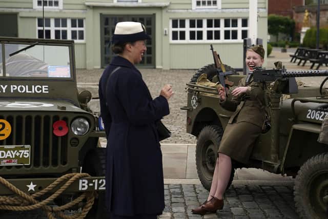 Reenactors in World War Two clothing talk together as D-Day veterans are welcomed to the Portsmouth Historic Dockyard to commemorate the 77th anniversary of the Normandy Landings. Picture: Steve Parsons/PA Wire