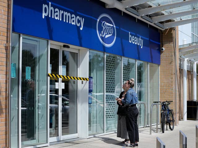 Customers read the signs on the door at Boots, which is closed after flooding at Ocean Retail Park in Portsmouth
Picture: Chris Moorhouse (jpns 280721-37)