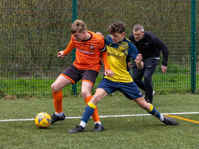 Action from the 2-2 draw between the under-18s of Moneyfields (blue/yellow kit) and AFC Portchester (orange/black kit). Picture: Mike Cooter
