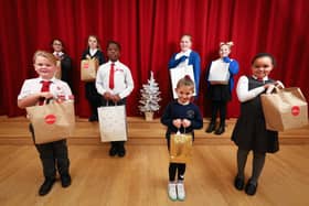 From left, Teddy, 7, Elizabetta, 10, Alicia, 10, Mark, 10, Freya, 10, Nellie, 5, Betty, 8 and Isabelle, 7, with their kindness bags. The children are from St Paul's Catholic Primary School, Beacon View Primary School, and Victory Primary School. The bags will be given to local families at Christmas. Picture: Chris Moorhouse (jpns 071221-18)