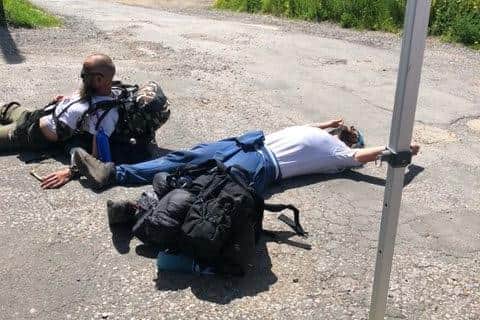 Crashed out: two of the three fundraisers collapse to the floor after completing the final leg of their "bike and hike" trek from London to Wickham.
Picture: Sam Stephenson