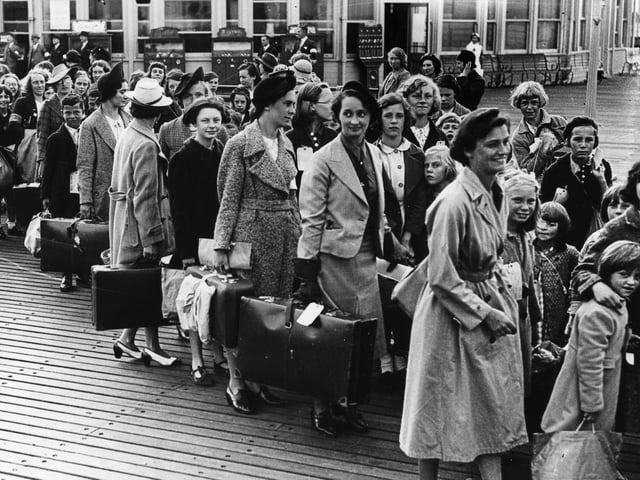 Evacuees line up for the boats. The News PP300
