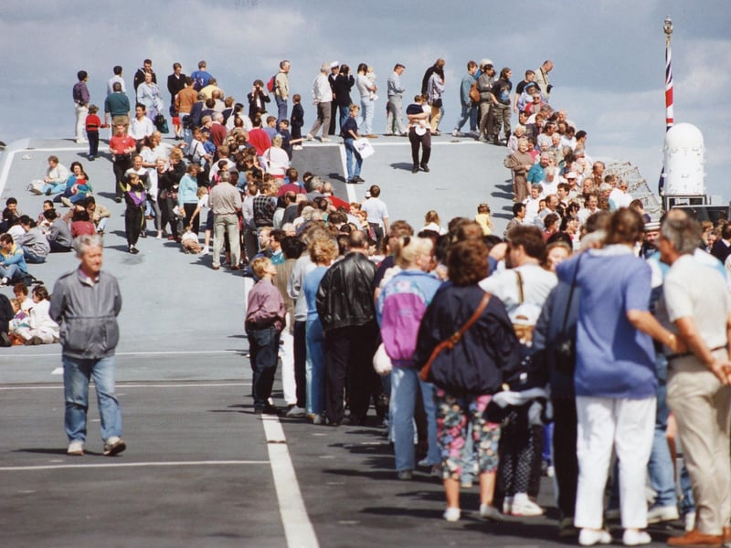 Visitors line up along the platform to disembark from HMS Ark Royal at Navy Days in 1992. The News PP942