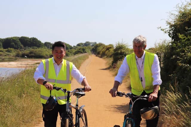 Alan Mak MP cycling on the Hayling Billy Trail with Hayling County Councillor Lance Quantrill