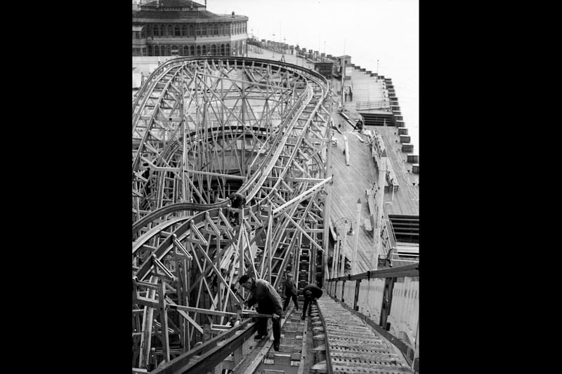 February 1936:  Workmen repainting the rollercoaster at Southsea funfair.  (Photo by Fox Photos/Getty Images)