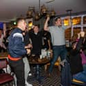 Fans in Cosham's Red Lion pub elebrate England scoring against Senegal in the last 16 match of the Fifa World Cup 2022. 

Photos by Alex Shute
