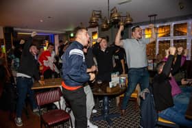 Fans in Cosham's Red Lion pub elebrate England scoring against Senegal in the last 16 match of the Fifa World Cup 2022. 

Photos by Alex Shute