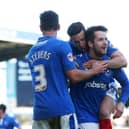 Marc McNulty celebrates with Enda Stevens and Conor Chaplin after scoring for Pompey against Notts County in March 2016. Picture: Joe Pepler