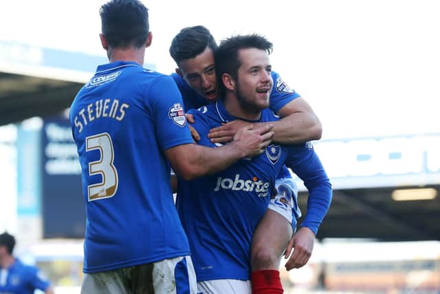 Marc McNulty celebrates with Enda Stevens and Conor Chaplin after scoring for Pompey against Notts County in March 2016. Picture: Joe Pepler