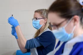 Nurses Sarah Anderson (left) and Amy Addison mix the Pfizer vaccines so they are ready to use. Picture by Simon Hulme