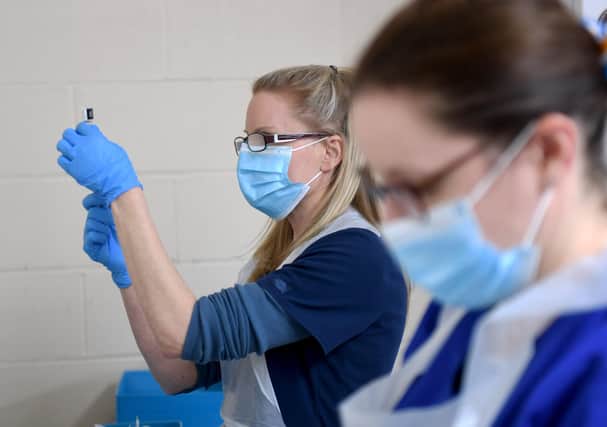 Nurses Sarah Anderson (left) and Amy Addison mix the Pfizer vaccines so they are ready to use. Picture by Simon Hulme