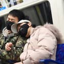 A man and a woman wearing a face masks while travelling on a tube train on the Jubilee Line of the London Underground. Picture: Victoria Jones/PA Wire