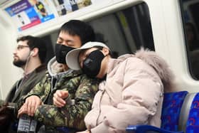 A man and a woman wearing a face masks while travelling on a tube train on the Jubilee Line of the London Underground. Picture: Victoria Jones/PA Wire
