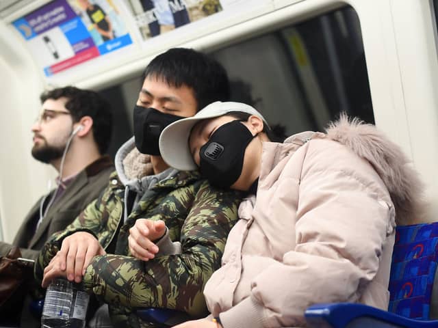 A man and a woman wearing a face masks while travelling on a tube train on the Jubilee Line of the London Underground. Picture: Victoria Jones/PA Wire