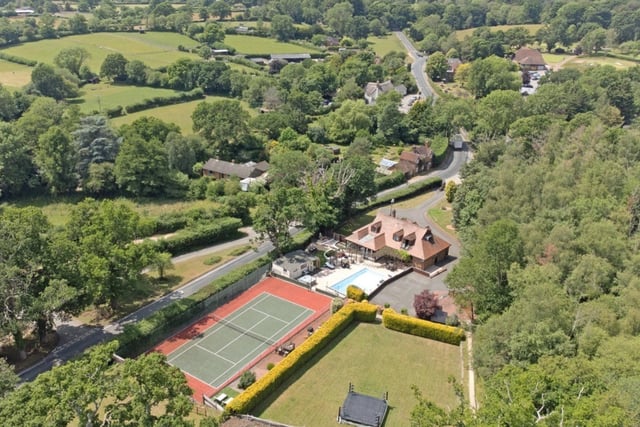 This property has five bedrooms, four bathrooms and two reception rooms. Complete with a swimming pool and a tennis court, this home is perfect if you want a large space.