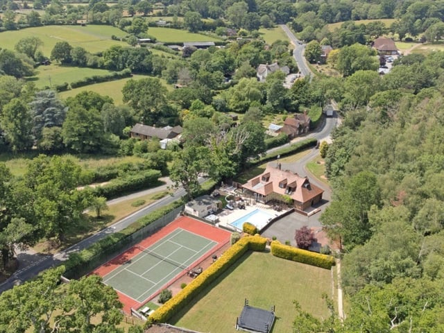 This property has five bedrooms, four bathrooms and two reception rooms. Complete with a swimming pool and a tennis court, this home is perfect if you want a large space.