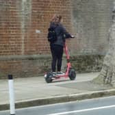 A Voi scooter being rode on the pavement on Ordnance Road, Portsea in May 2022