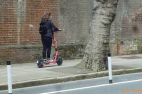A Voi scooter being rode on the pavement on Ordnance Road, Portsea in May 2022