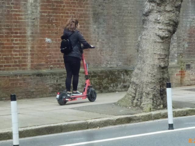 A Voi scooter being rode on the pavement on Ordnance Road, Portsea in May 2022