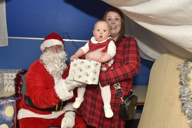 Beacon View Primary Academy in Paulsgrove held their annual community Christmas lunch on Friday, December 22.

Pictured is: Joanne Parfitt with her daughter Hermione Toovey (10 months old) meeting Father Christmas.

Picture: Sarah Standing (221223-4086)