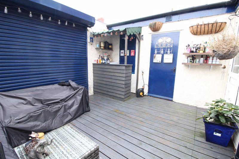 The rear garden boasts a converted private bar - perfect for the hot summer nights.