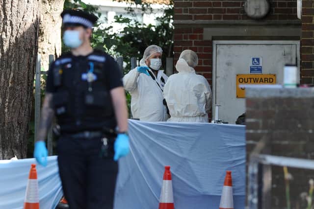 Detectives have launched an investigation after a man's body was found outside Cosham Library on Friday morning, July, 3.
Pictured is: Forensic officers investigating the scene.
Picture: Sarah Standing (030720-5310)