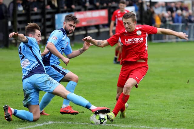 AFC Portchester's Conor Bailey, left, puts a tackle in on Horndean's Zack Willett. Picture: Sam Stephenson