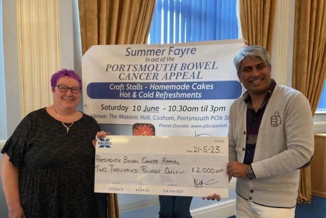Professor Jim Khan accepts a cheque on behalf of the Portsmouth Bowel Cancer Appeal.