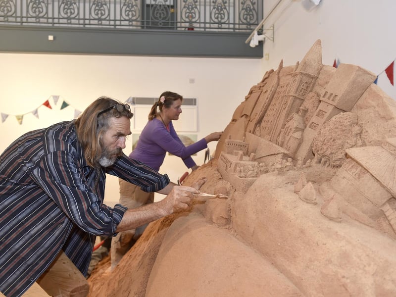 Pictured is: Sand artists Paul and Remy Hoggard.
Picture: Sarah Standing (280723-7212)