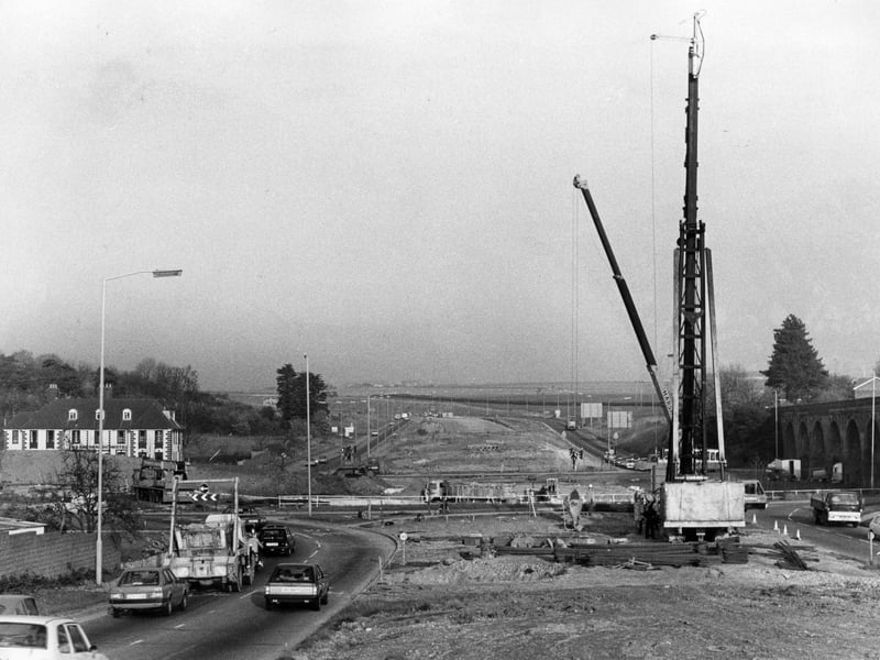 Fareham: A view of the work in progress on the Delme Roundabout Flyover, showing the giant pile-driver in position and the route that the road will take in November 1983. The News PP987