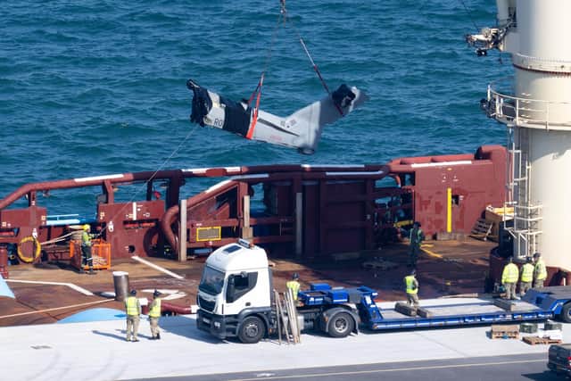 The recovered tail section of the Merlin Mk4 helicopter is bought into Portland Port, on September 18, 2024 in Portland, England.