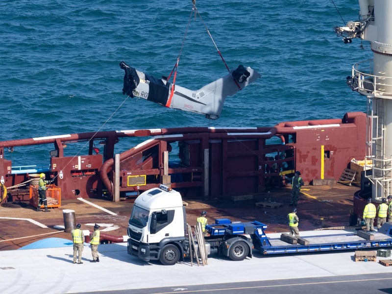 The recovered tail section of the Merlin Mk4 helicopter is bought into Portland Port, on September 18, 2024 in Portland, England. A Merlin Mk4 helicopter ditched into the sea close to HMS Queen Elizabeth while conducting night training off the Dorset coast on September 5. The pilot, Lt Rhodri Leyshon, was killed and two of the three crew from the 846 Naval Air Squadron aircraft were rescued.