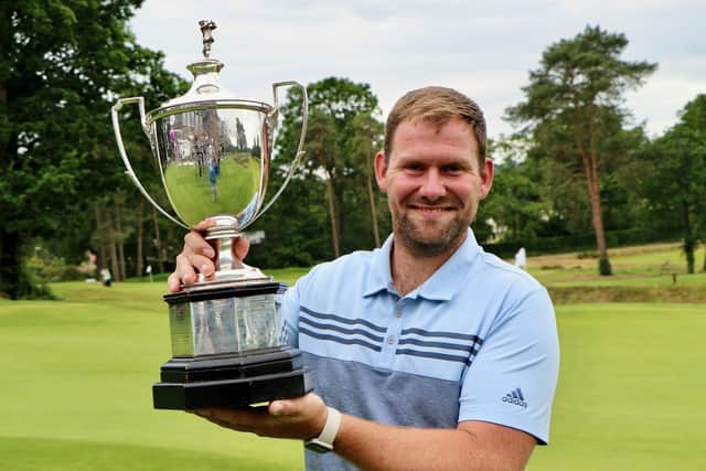 Avid Pompey fan Sam Parsons holding the Sloane-Stanley Challenge Cup after beating Stoneham’s Ryan Henley in the final of the 119th Hampshire, Isle of Wight and Channel Islands Amateur Championship at Blackmoor GC. Picture: Andrew Griffin