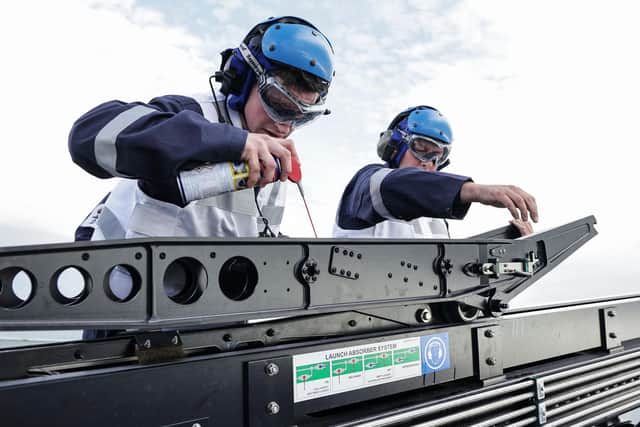 Sailors oil up the launch platform used to deploy the Banshee drones from HMS Prince of Wales. Photo: LPhot Ben Corbett