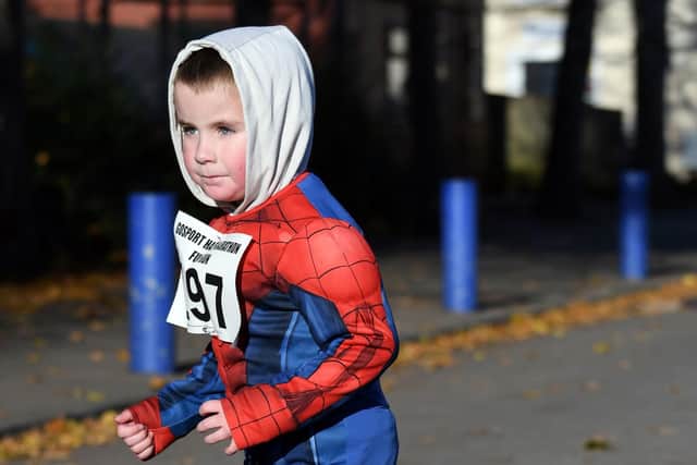 A youngster takes on the children's course in a Spiderman costume. Picture: Neil Marshall