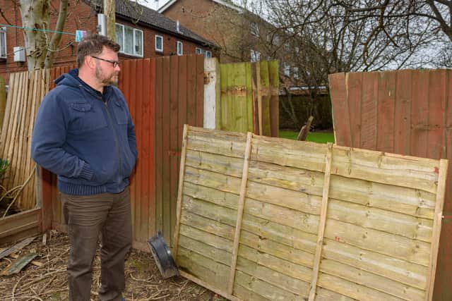 Ed Gamson at the bottom of his garden with the wind-damaged fence. Picture: Vernon Nash (070320-027