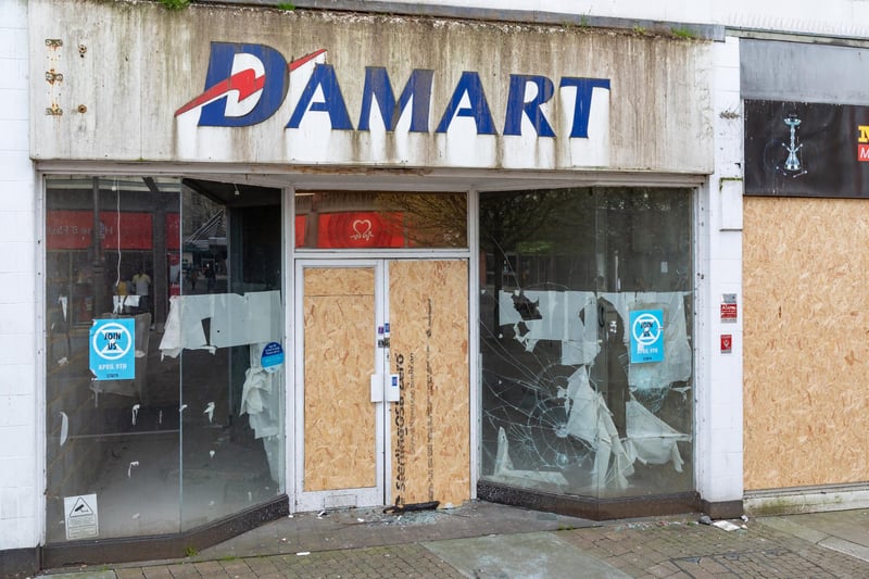 Smashed windows of the former Damart shop on Arundel Street