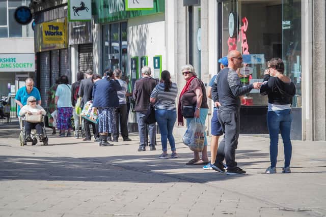 People queuing outside Lloyds bank in Commercial Road in June. Picture: Habibur Rahman