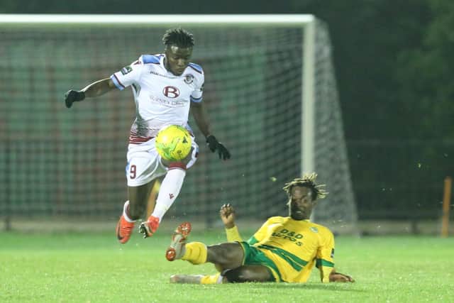 Dan Ajakaiye (white shirt) in action for Hastings