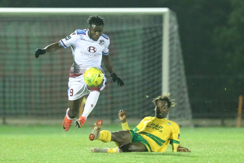 Dan Ajakaiye (white shirt) in action for Hastings